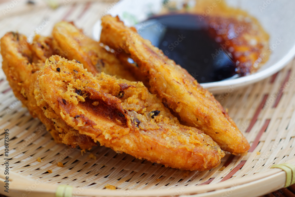 Close up of fried bananas on rattan tray. A traditional food in some places in south east asia. Close up of fried bananas on rattan tray. A traditional food in some places in south east asia.