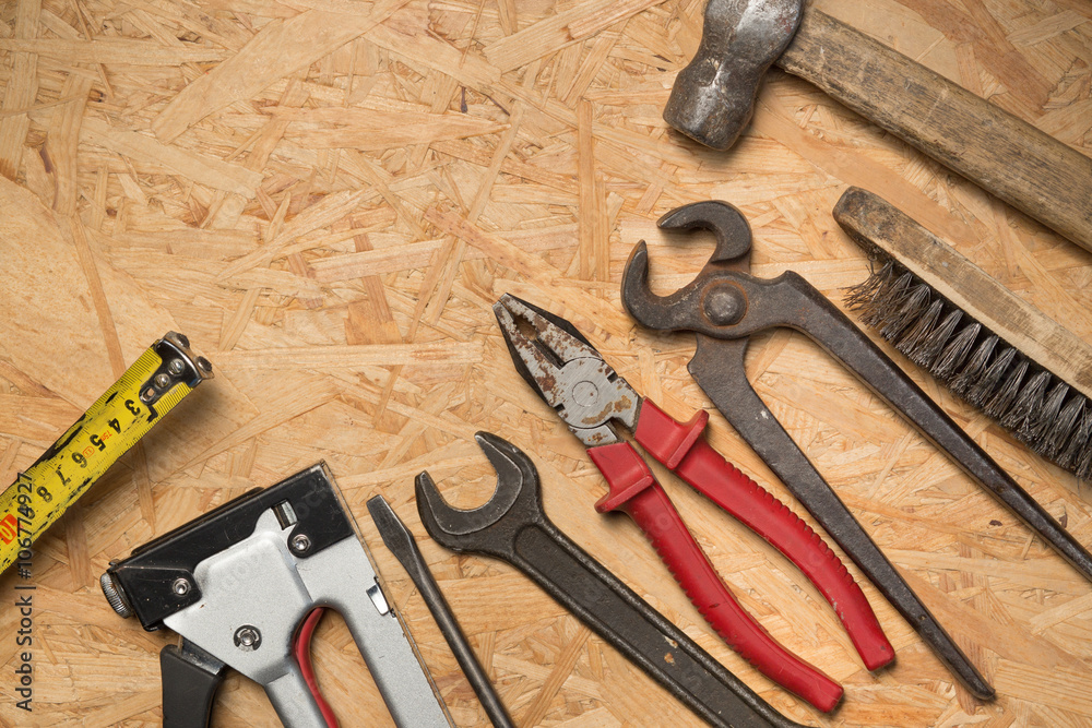 Tools set on osb panel with copy space. Carpenter workplace on wooden background. Top view. Tools set on osb panel with copy space. Carpenter workplace on wooden background. Top view.