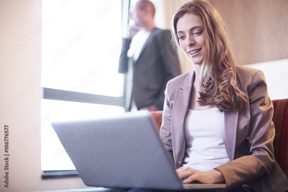 Businesswoman using laptop in hotel room Businesswoman using laptop in hotel room