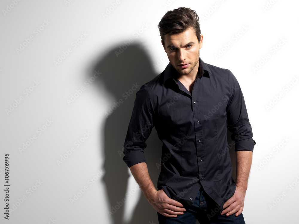 Fototapeta premium Fashion portrait of young man in black shirt