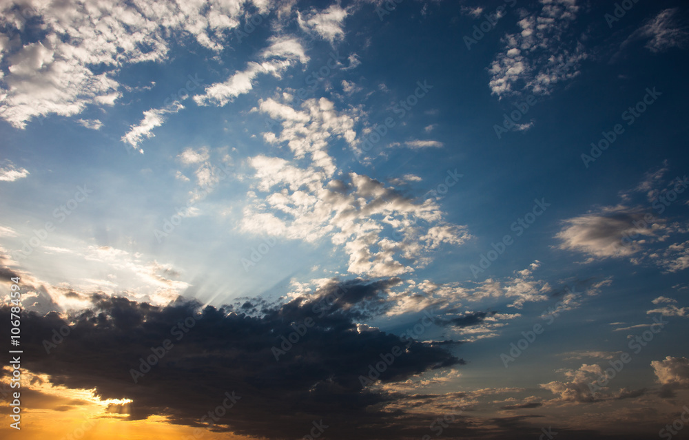 Cloudscape with the sun rays radiating from behind the cloud Cloudscape with the sun rays radiating from behind the cloud