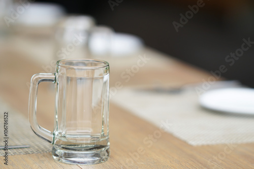 empty glass mug  cutlery and white dish