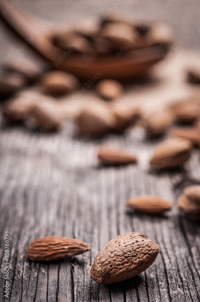 Tasty almond nuts on rustic wooden background Tasty almond nuts on rustic wooden background