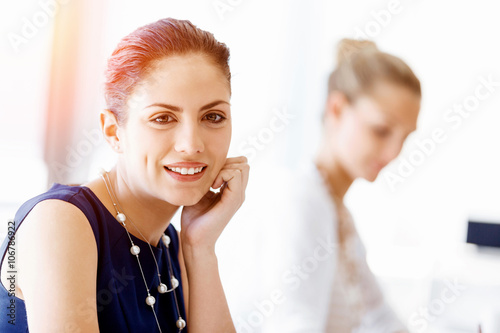 Attractive office worker sitting at desk