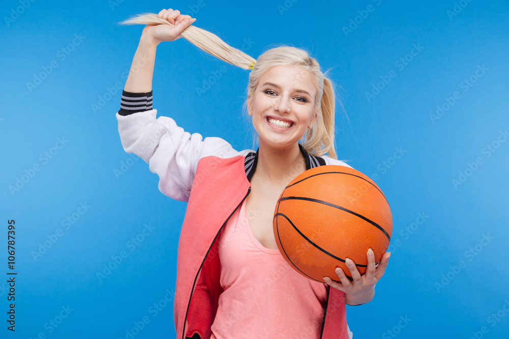 Smiling woman holding basketball ball