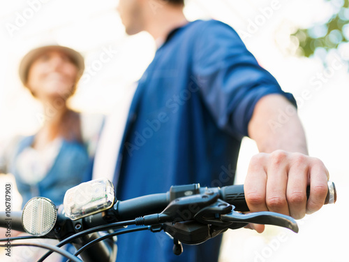 Happy couple in city with bike
