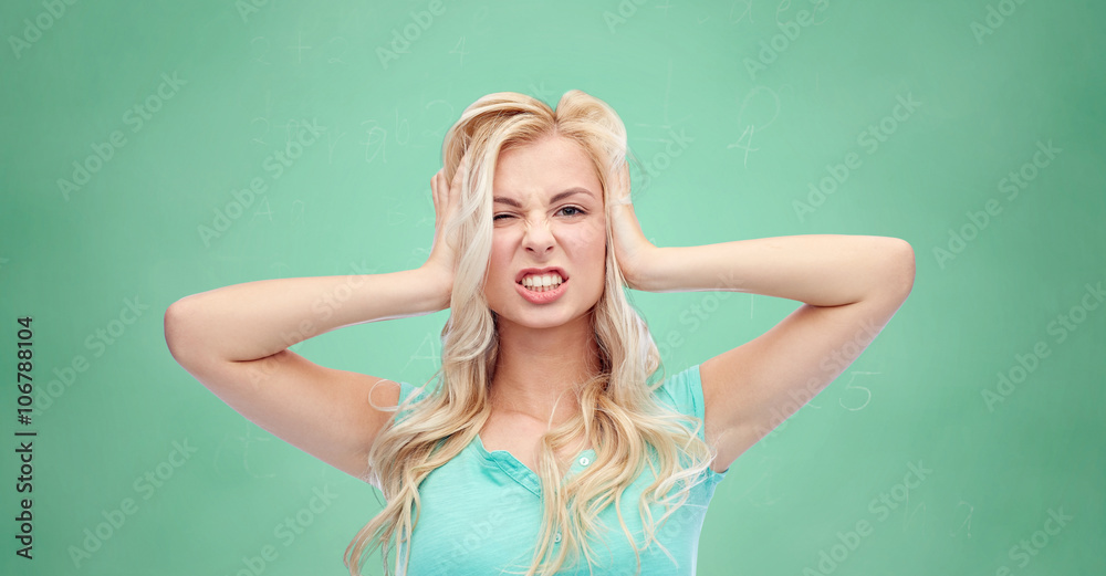 young woman holding to her head and screaming