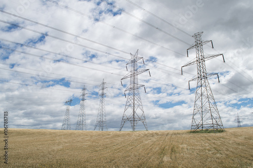 High-voltage towers on sky background