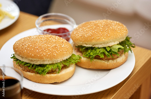 close up of two hamburgers on table