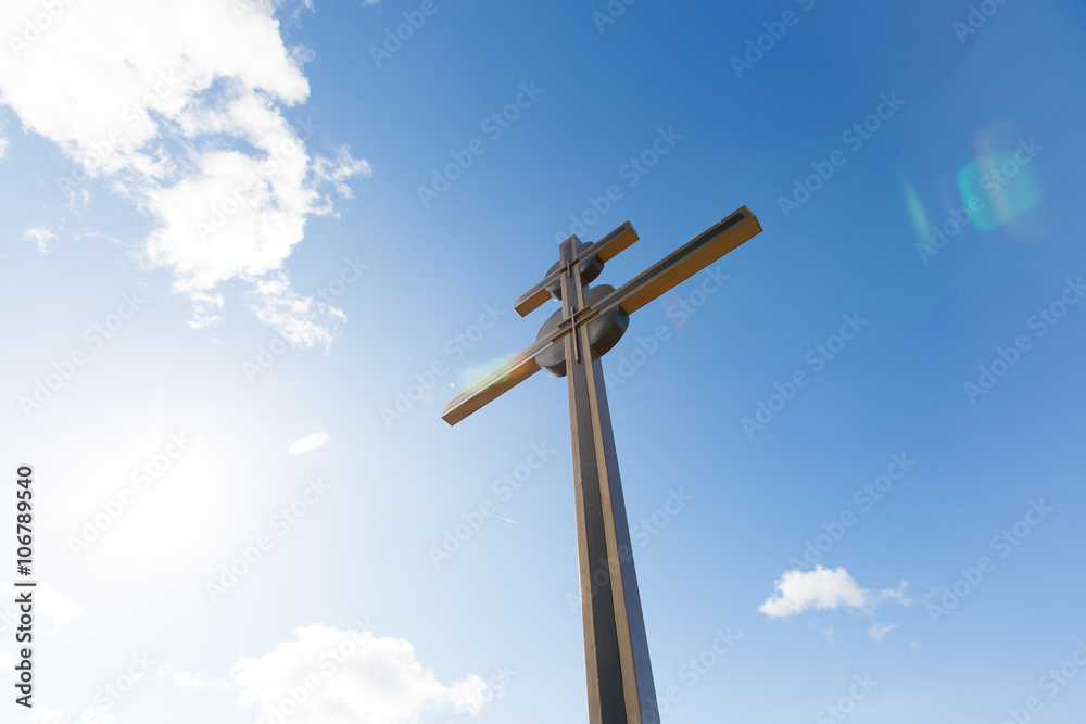 Cross and sunny sky background