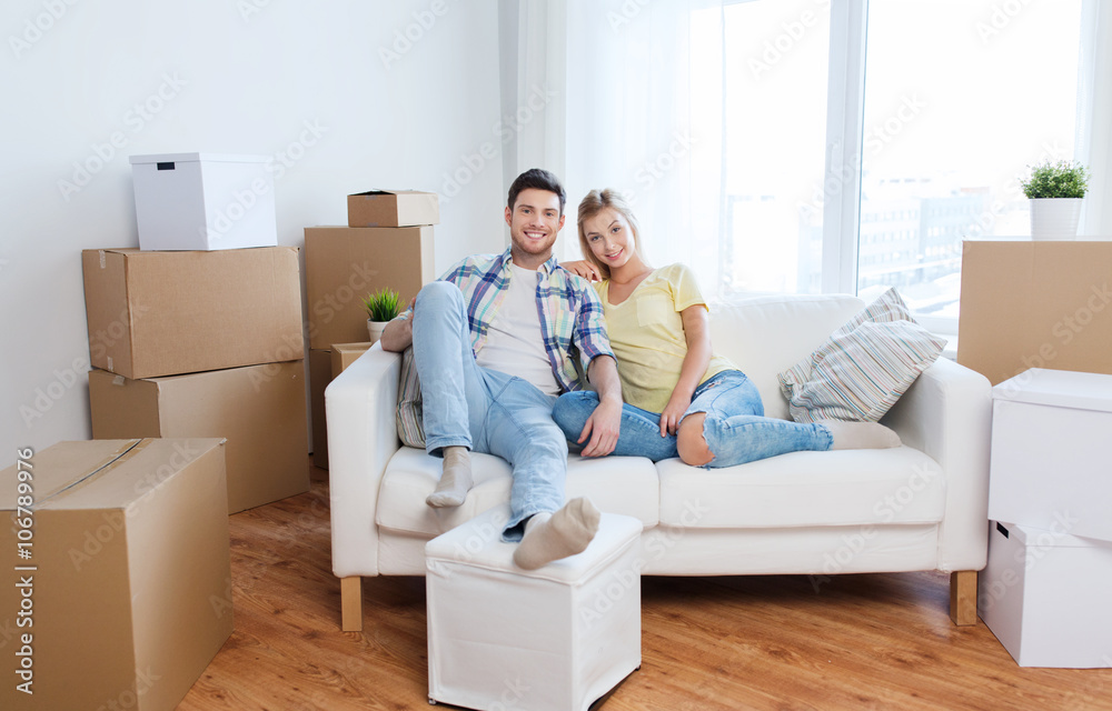 happy couple with big cardboard boxes at new home happy couple with big cardboard boxes at new home