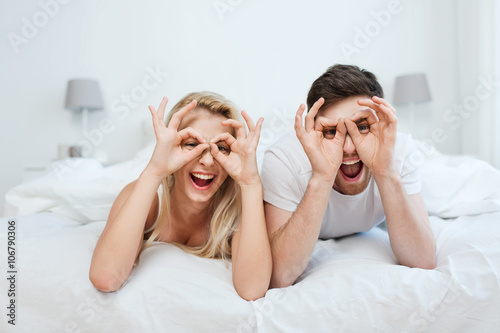 happy couple lying in bed at home