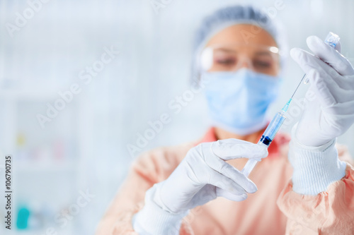 Doctor is preparing for vaccination photo