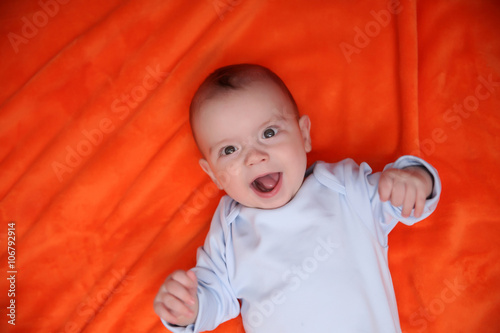 Lovely baby on orange backg...