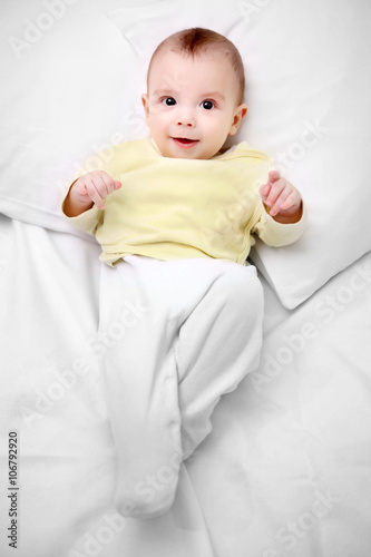 Loving baby lying on soft b...