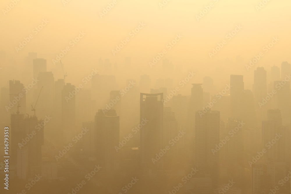 Buildings under construction with cranes in misty morning, Bangkok, Thailand