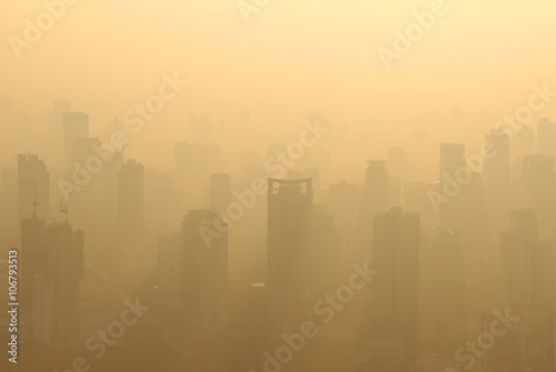Buildings under construction with cranes in misty morning, Bangkok, Thailand