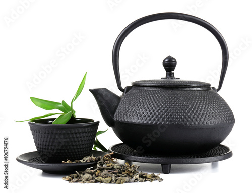 Green tea with black utensils, isolated on white