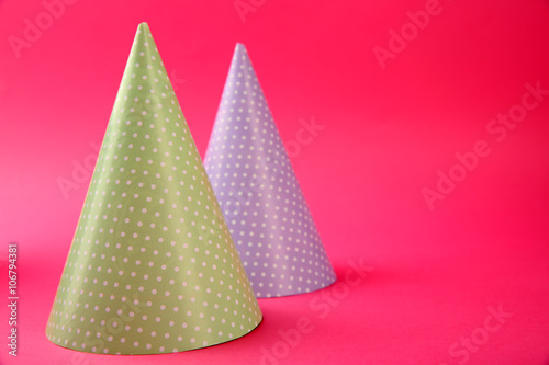 Two dotted Birthday hats on pink background