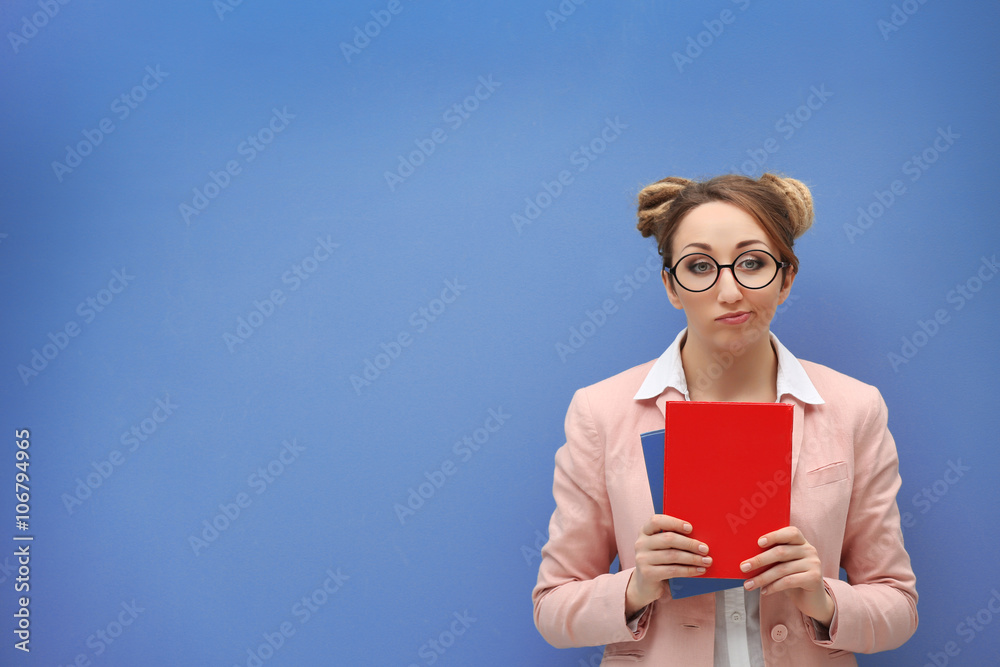 Attractive young blond girl against light blue wall. Attractive young blond girl against light blue wall.