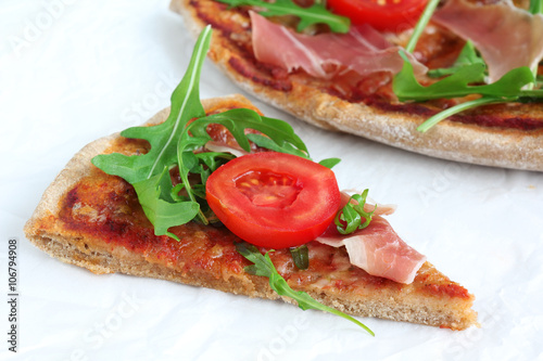 Pizza with Porsciutto, cherry tomatoes and rocket salad