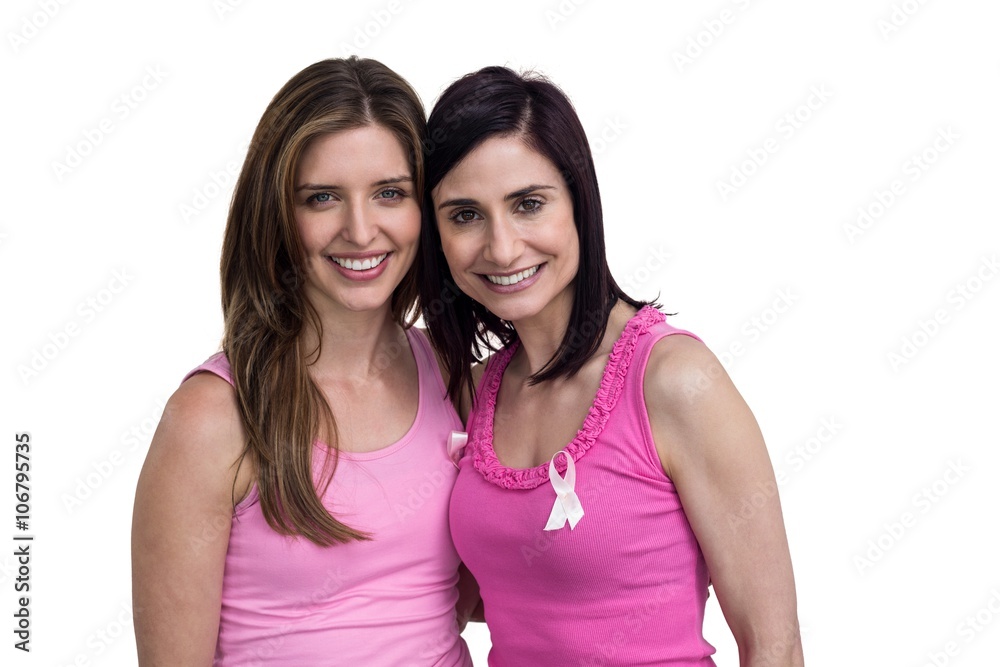 Smiling women in pink outfits posing for breast cancer awareness on white background Smiling women in pink outfits posing for breast cancer awareness on white background