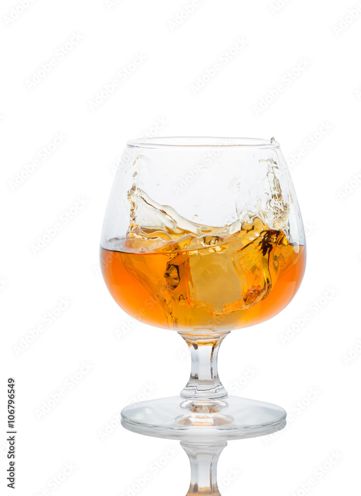 A glass of brandy on a white background. A glass of brandy on a white background.