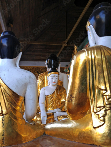 Gold and white Buddha statues at the Shwedagon Pagoda in Yangon,