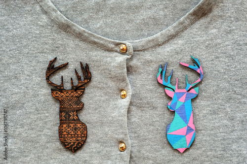 Wooden colored deers on grey pullover photo