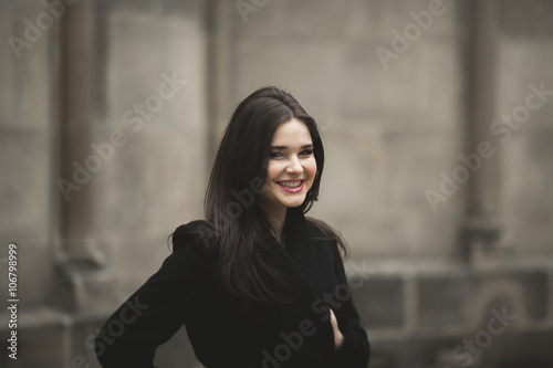 Beautiful brunette young woman posing on the street in old city © olegparylyak