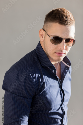 Portrait of attractive guy in sunglasses