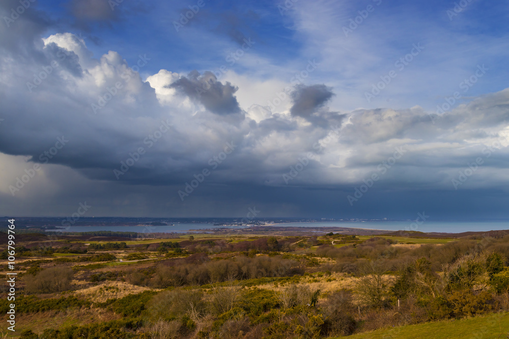 Rain-bearing clouds hang over the horizon over Poole Harbour