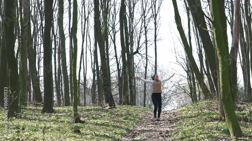 Sexy girl running in the woods. Slow motiom photo