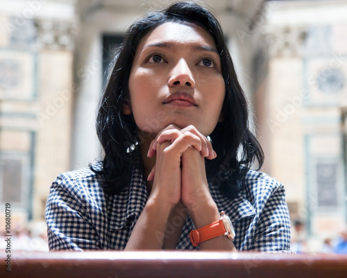 Woman praying in church