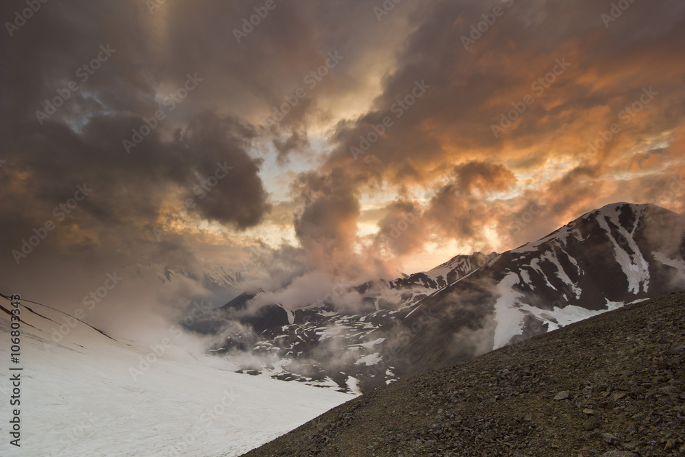  snowy peaks from mountains with beautiful sunset
