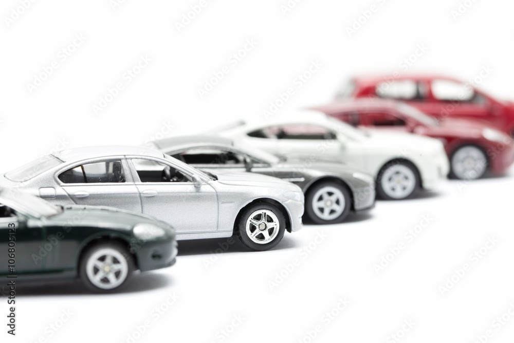 toy cars arranged on white background
