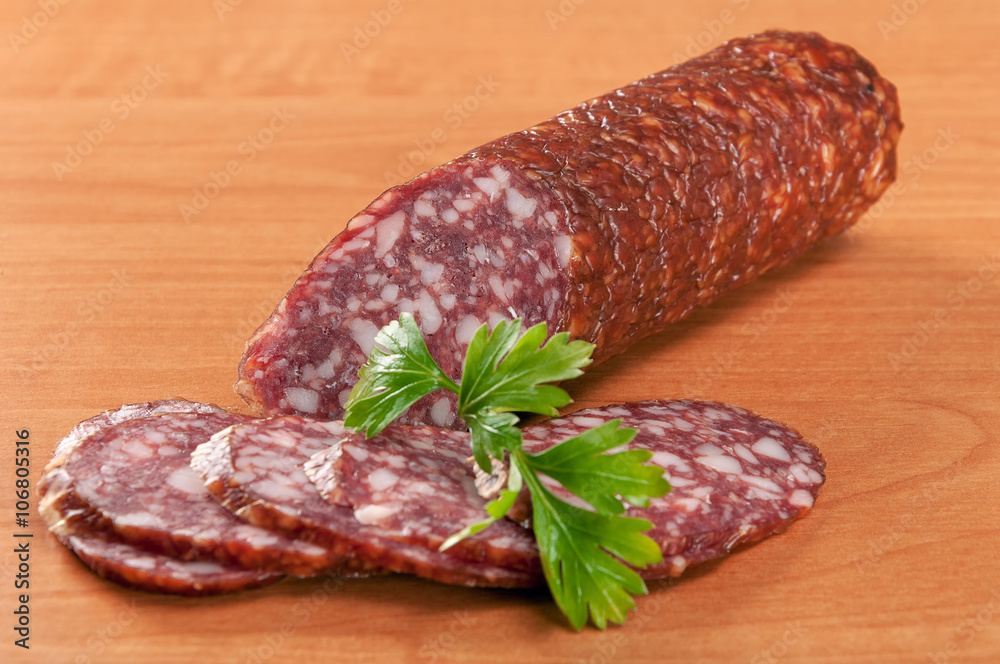 Salami for Breakfast with pepper on a wooden table Salami for Breakfast with pepper on a wooden table