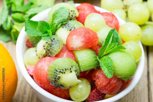 fruit salad with strawberries, oranges, kiwi, grape and watermel photo