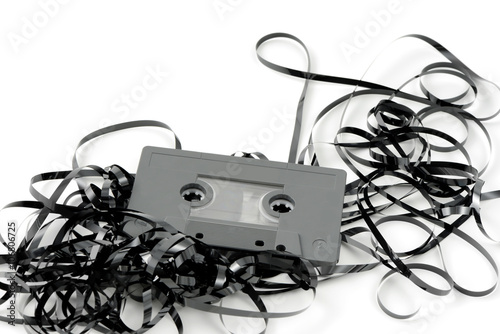 vintage audio cassette with tangled messy tape.