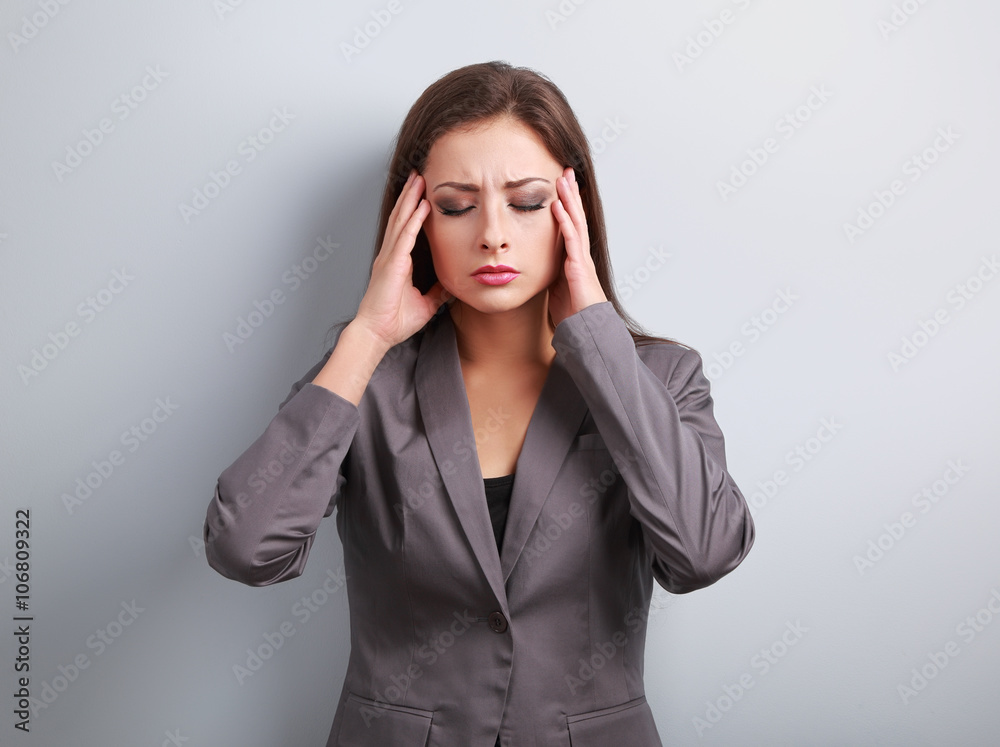 Unhappy stressed business woman in suit holding head the hands o Unhappy stressed business woman in suit holding head the hands o