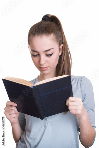 Young beautiful girl reading a book and thinking