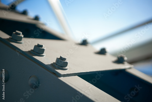 Fragment of a metal construction with bolts and nuts photo