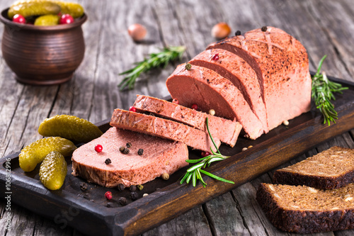 liver pate with cranberry, pickles and spices, close-up photo