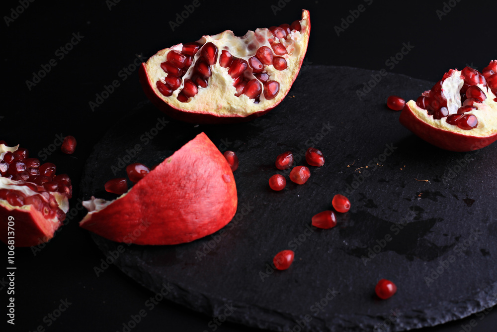 Fototapeta premium Pomegranate on black background. Colorful fruits on dark background