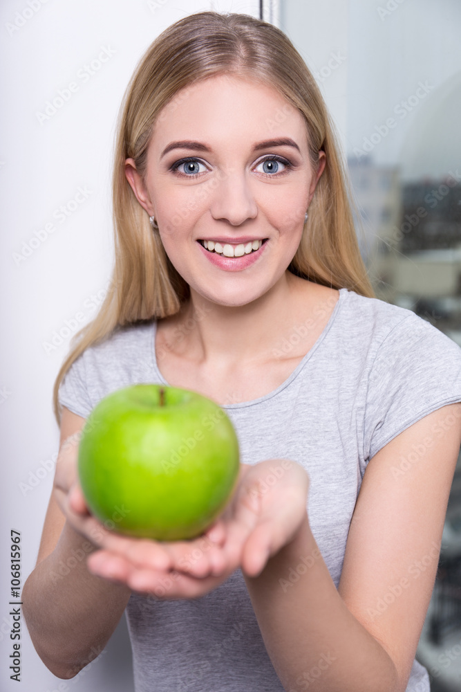 portrait of young smiling woman with green apple portrait of young smiling woman with green apple