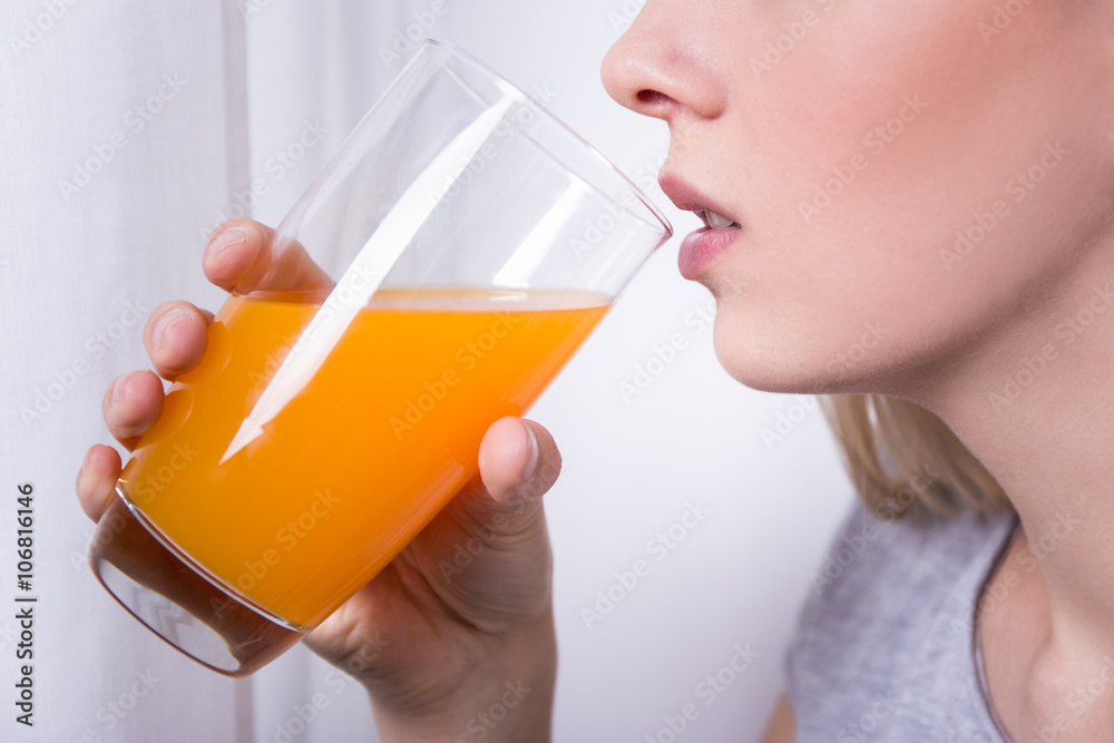 young beautiful woman drinking orange juice young beautiful woman drinking orange juice
