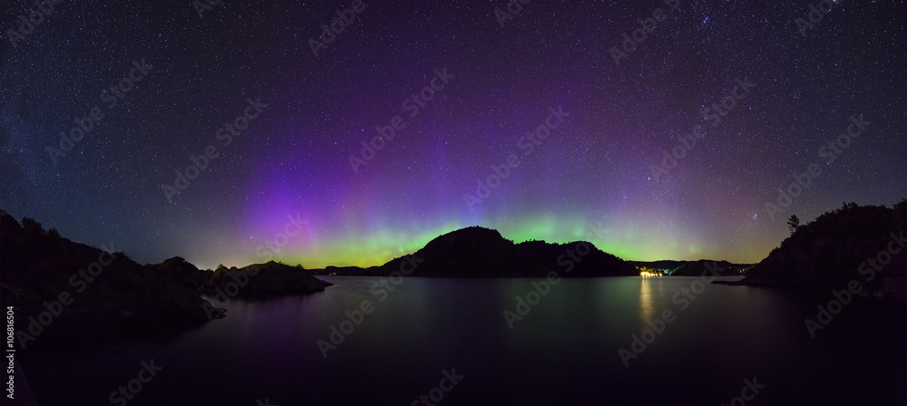 panoramic view of colorful northern lights (Aurora Borealis) at fjord landscape, Norway, Europe
