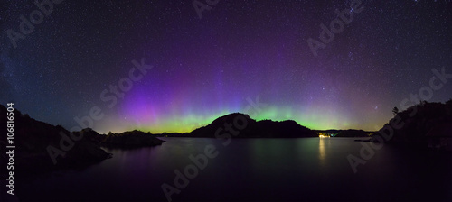 panoramic view of colorful northern lights (Aurora Borealis) at fjord landscape, Norway, Europe 