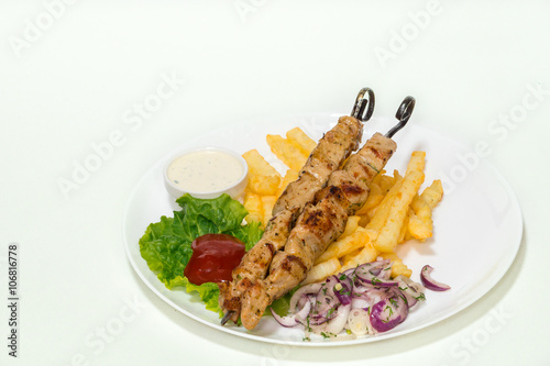 Skewer chicken, meat grilled with French fries, ketchup, cacık and onions marinated.Greek cuisine, Shashlik,souvlaki.