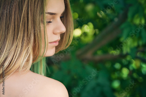 Portrait of beautiful young girl outdoors in summer